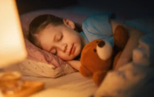 Little child is sleeping in the bed