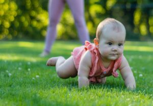Baby crawling with nanny exercising