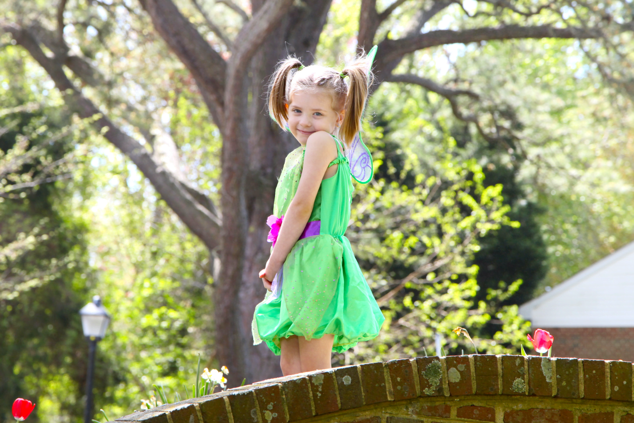 child learning playing make-believe dressed as fairy