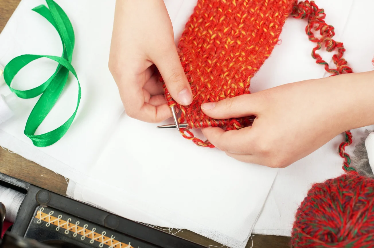 Child learning through play while knitting