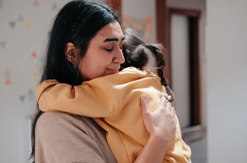 Child hugging nanny