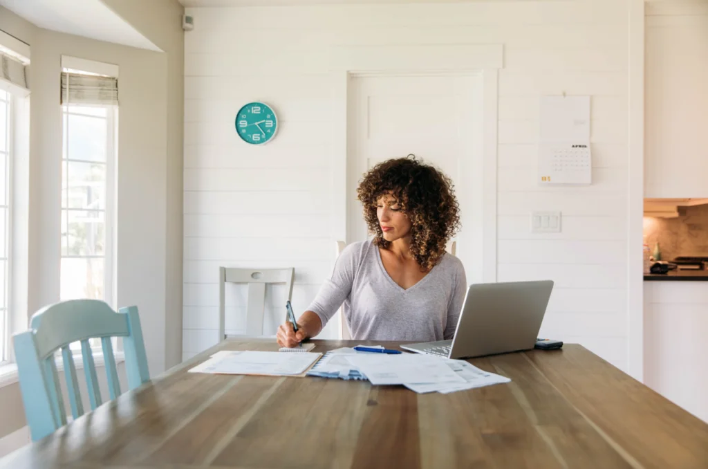 Woman calculating childcare costs before starting term