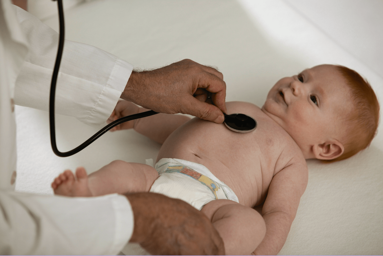 Newborn grunting and squirming examined by doctor