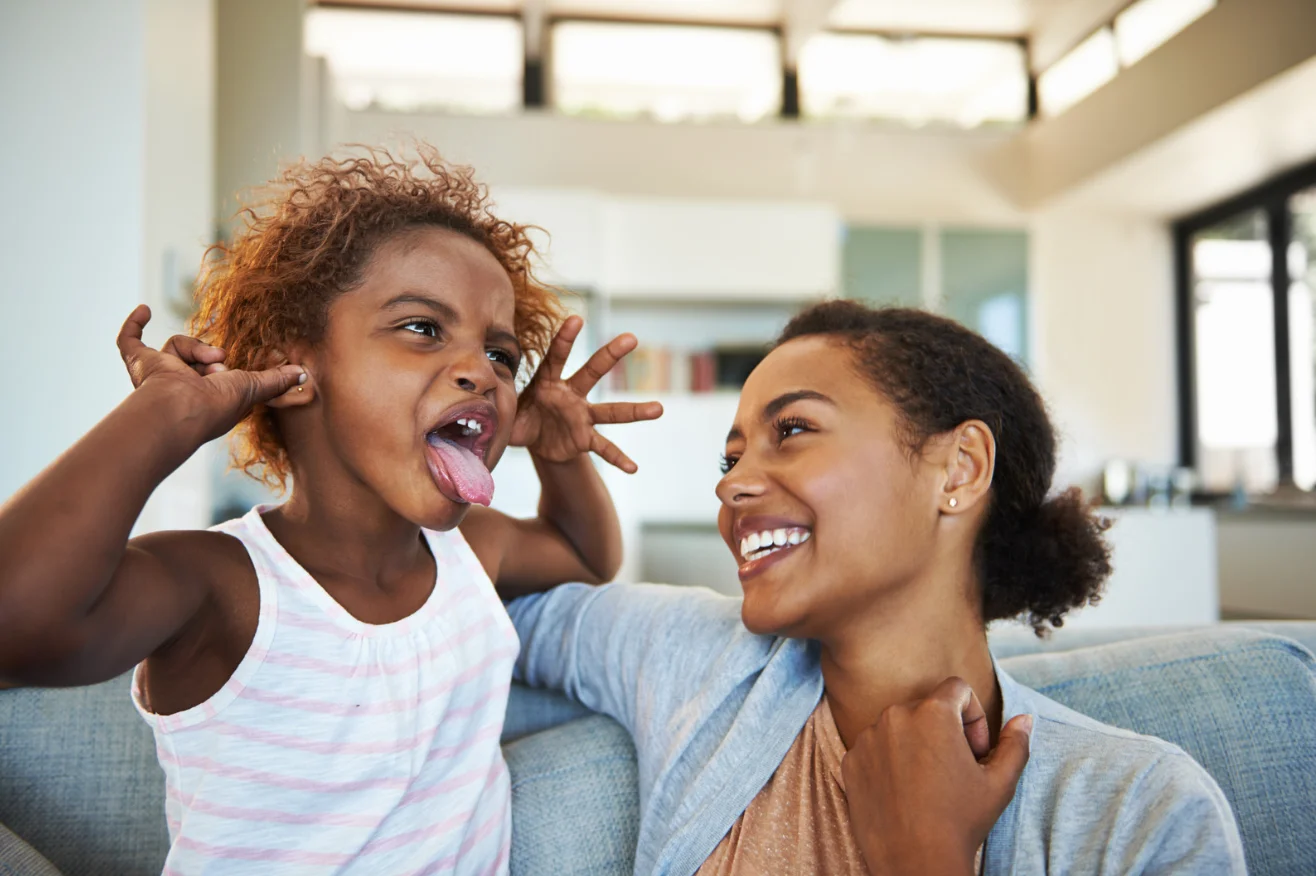mother learning how to be a good mother laughing with child