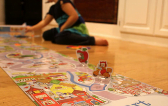 kid having great fun playing orchard toys board game to develop observation game
