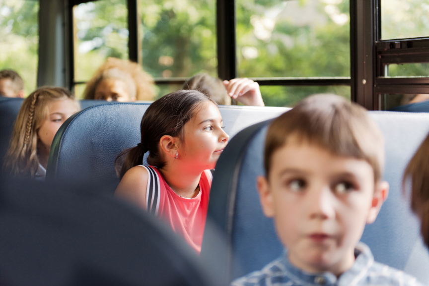 Young flyers taking bus to airport