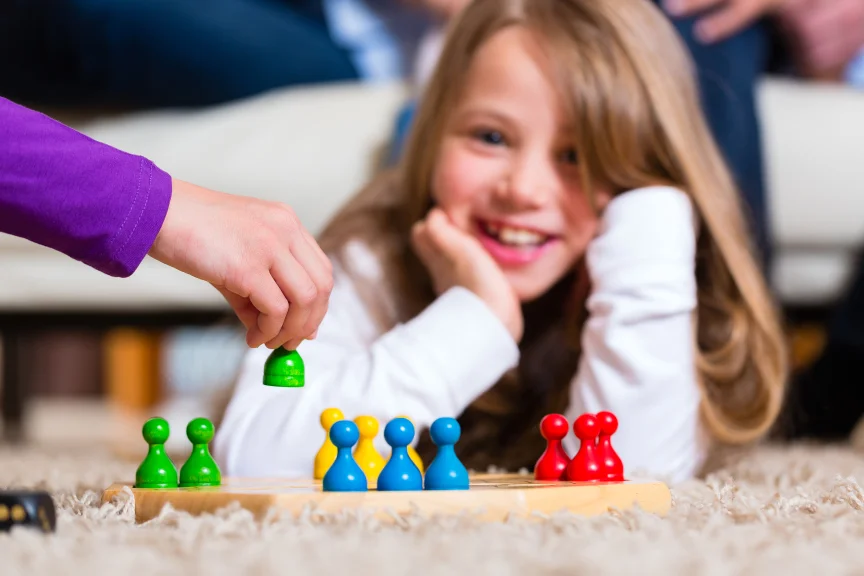 3 4 year old child playing fun board game