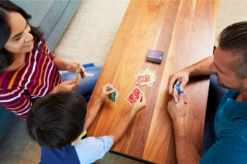 Family playing card games learning memory skills