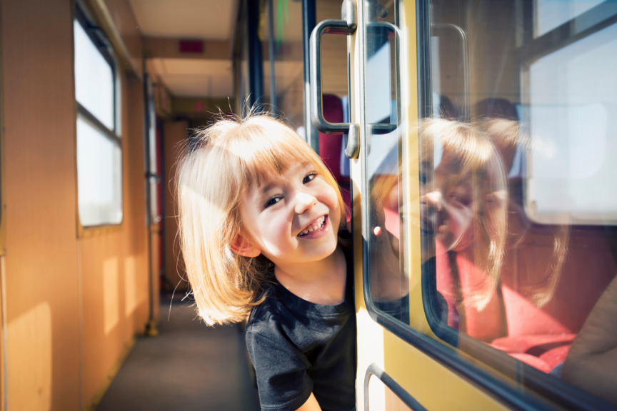 Child smiling travelling as an unaccompanied minor