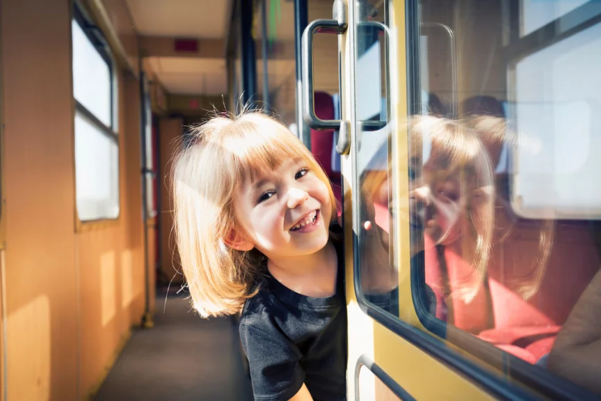 Child smiling travelling as an unaccompanied minor