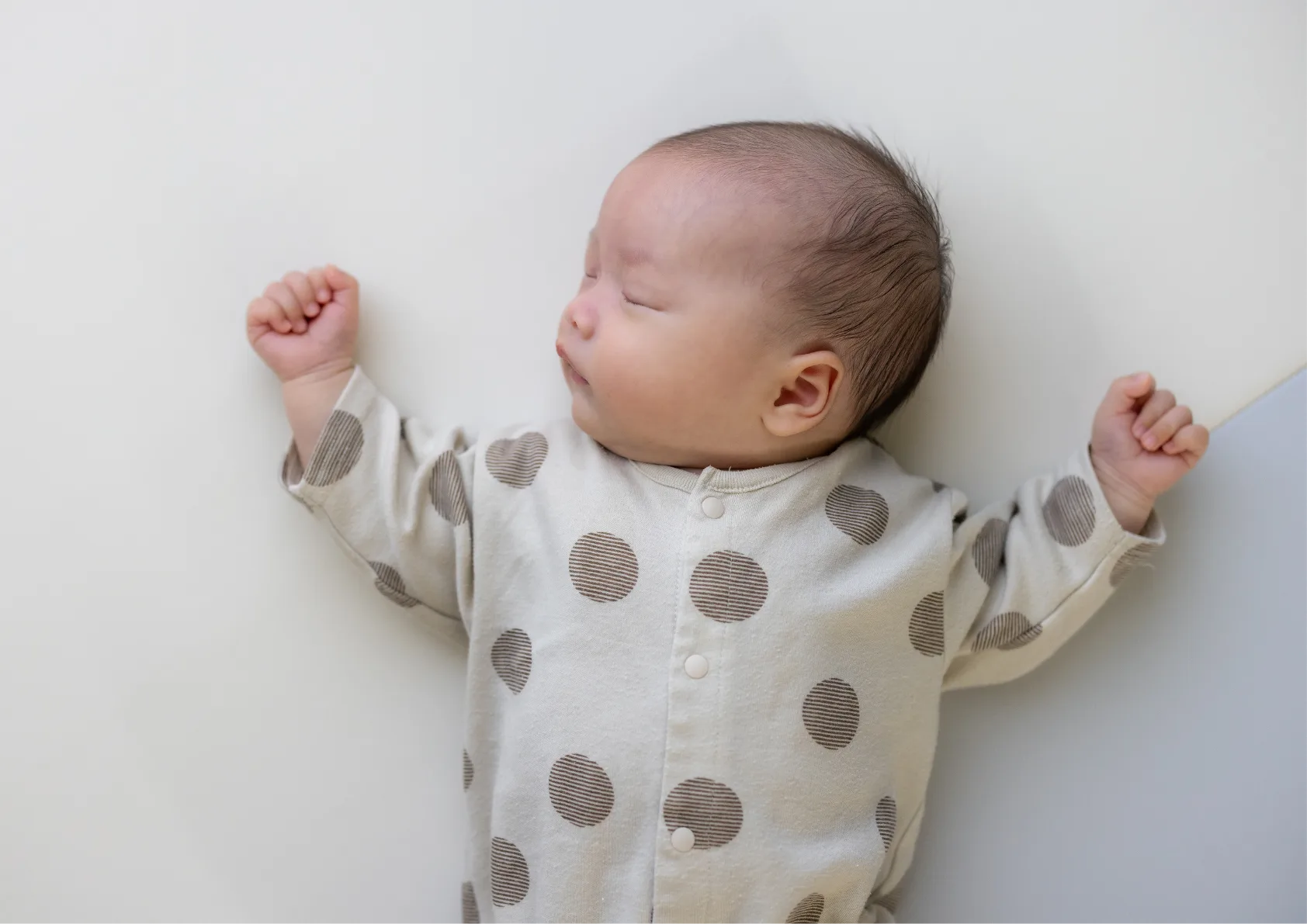 infant sleeping soundly in cot no sun hat