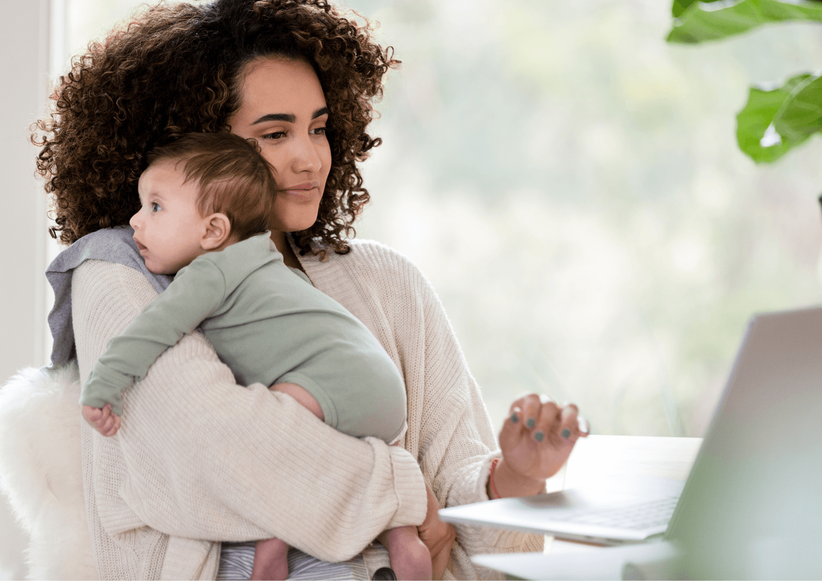 mum holding baby looking at national minimum wage payslip