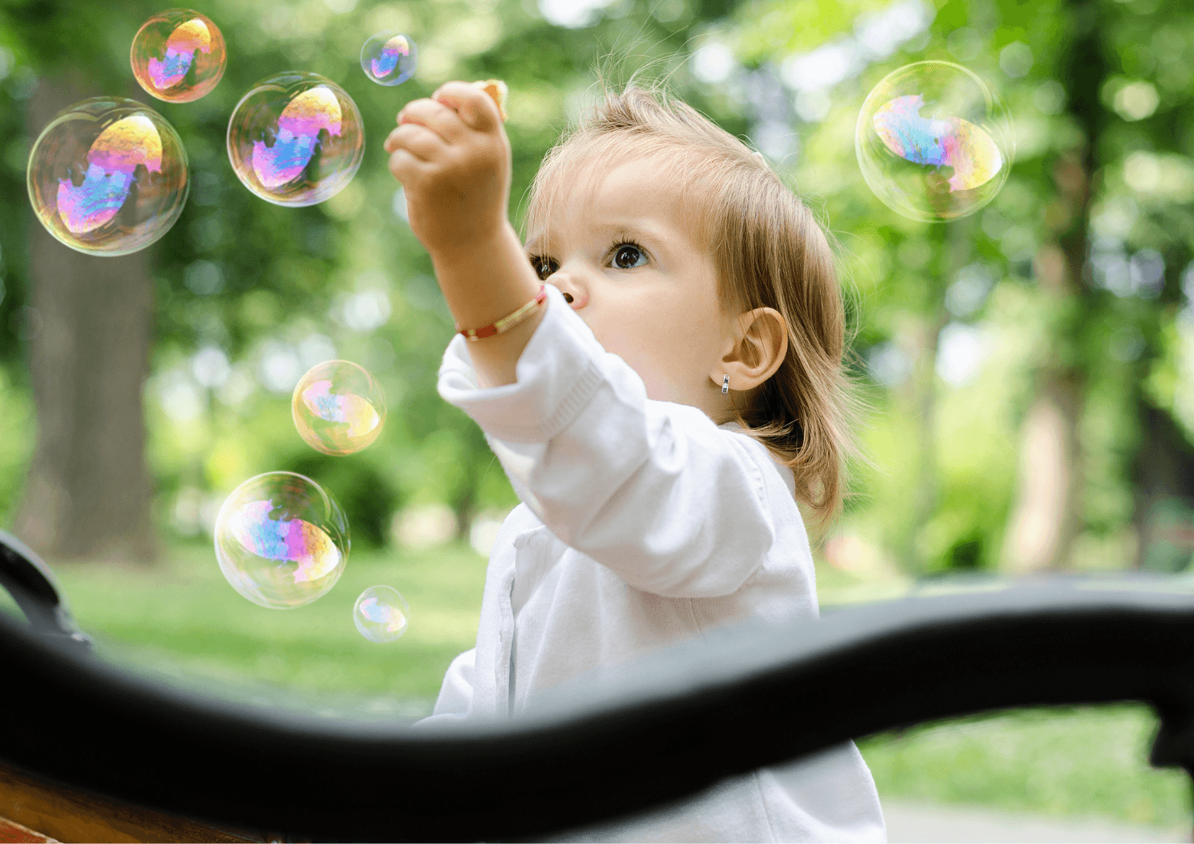 Baby boy playing with bubbles