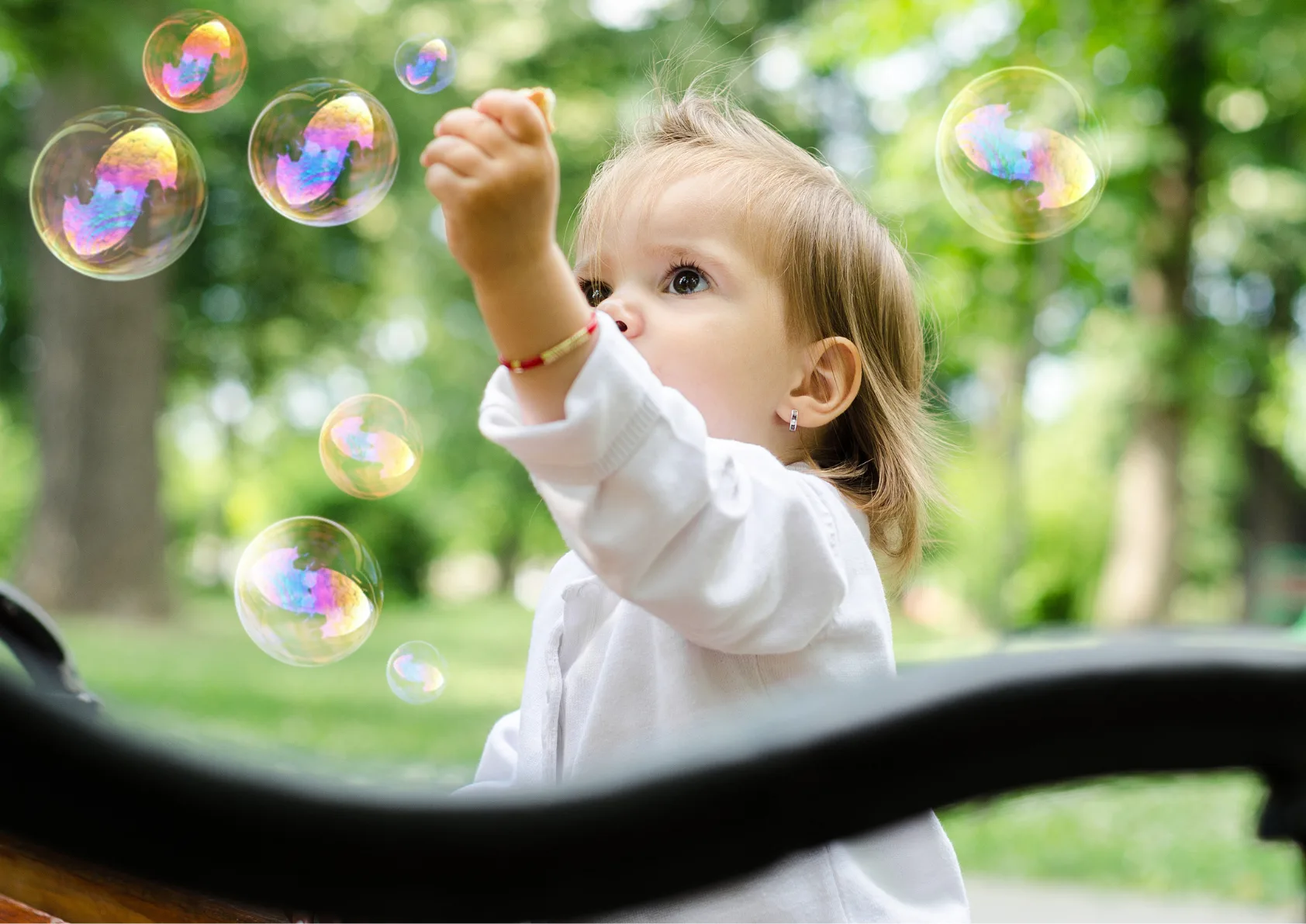 Baby boy playing with bubbles
