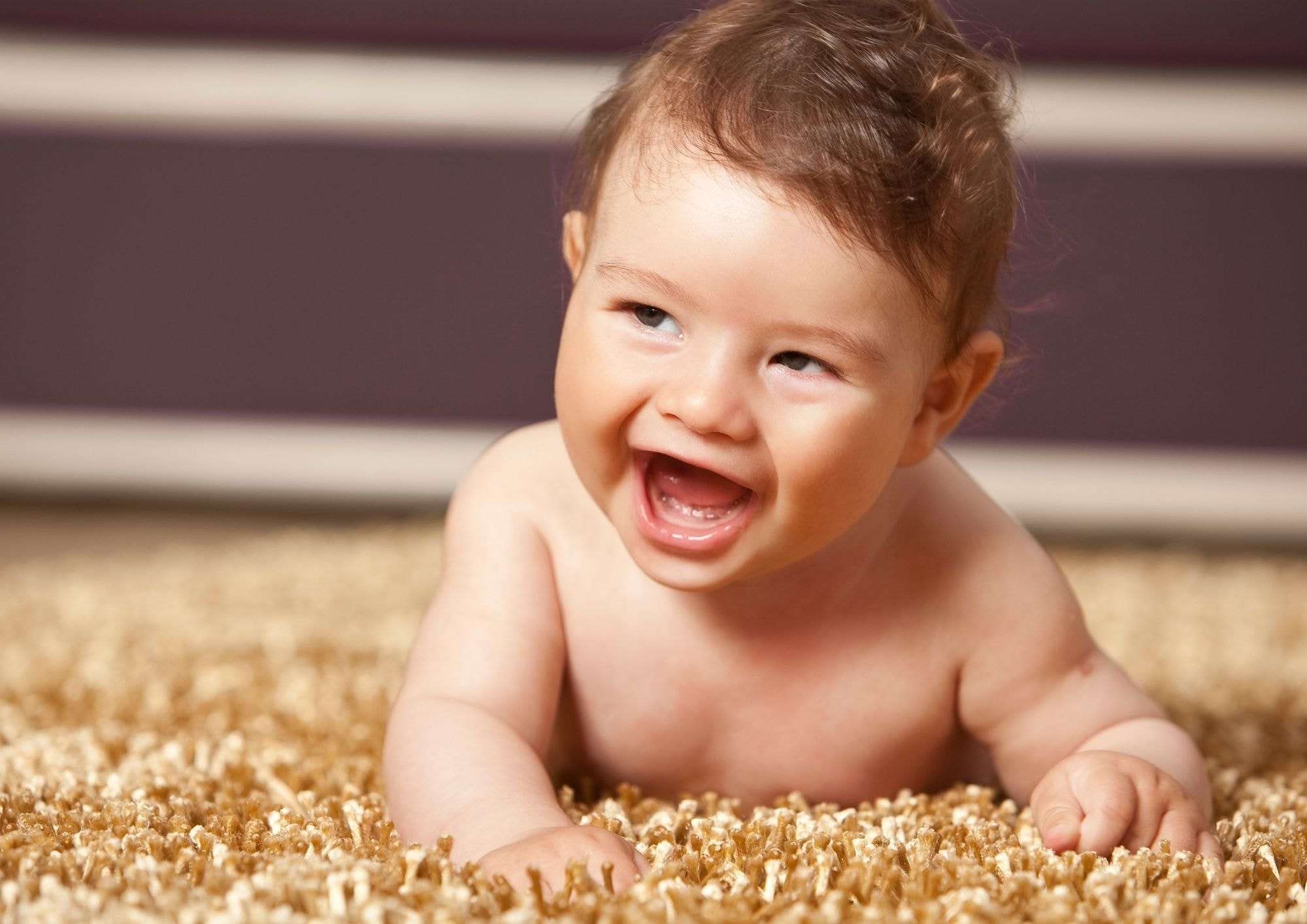 Young baby smiling at a laughing matter