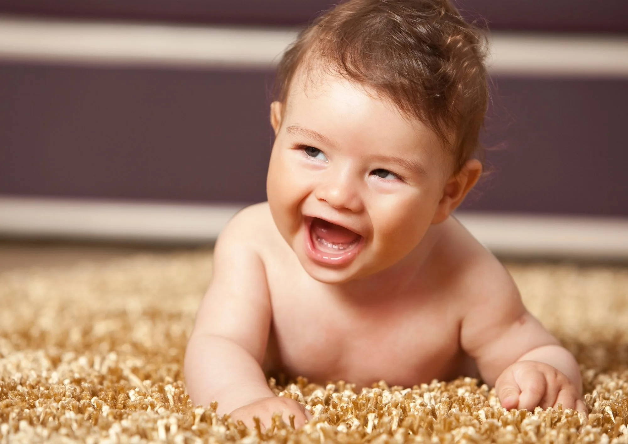 Young baby smiling at a laughing matter