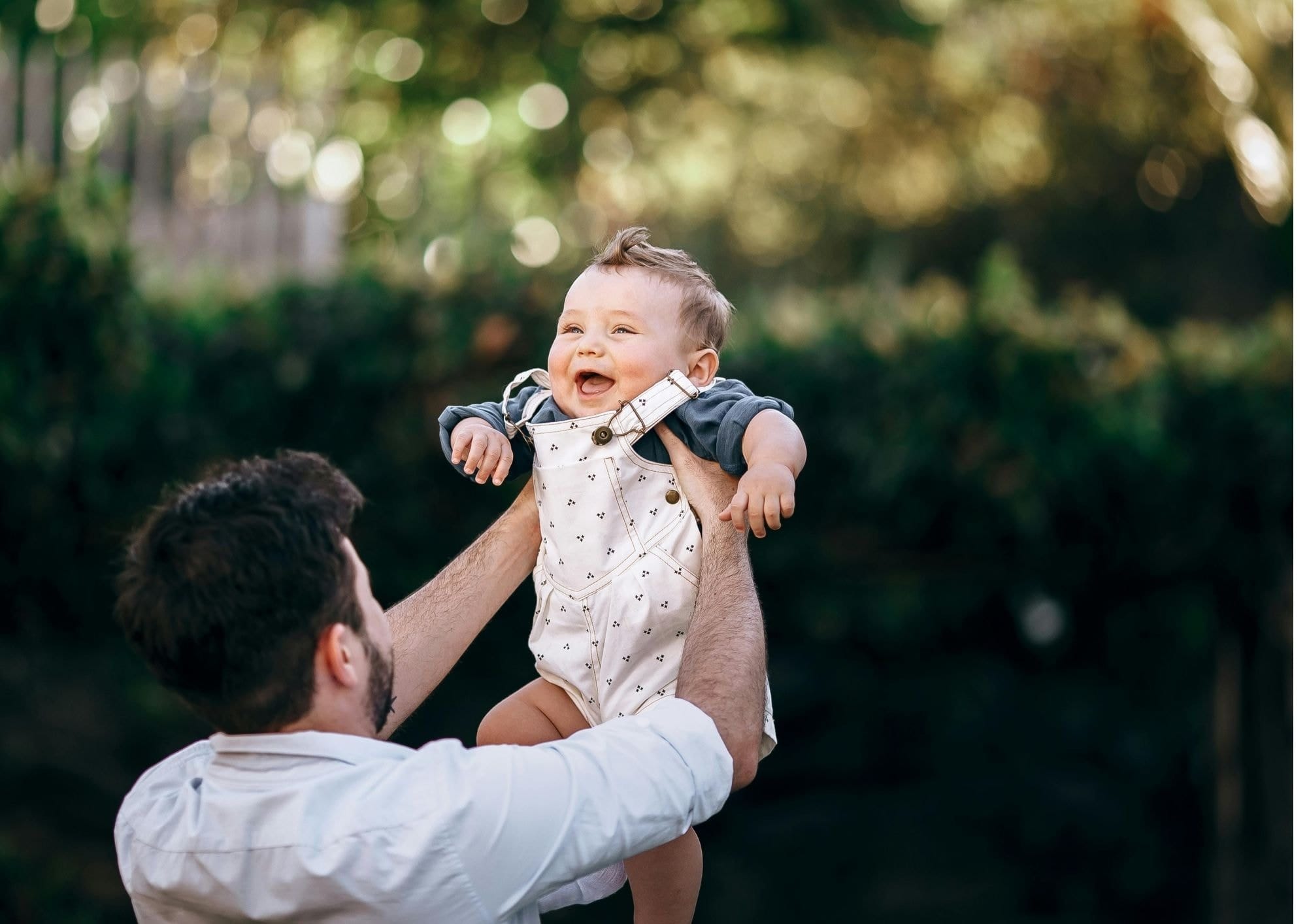 Infant being lifted by adults causing laughing sound effects
