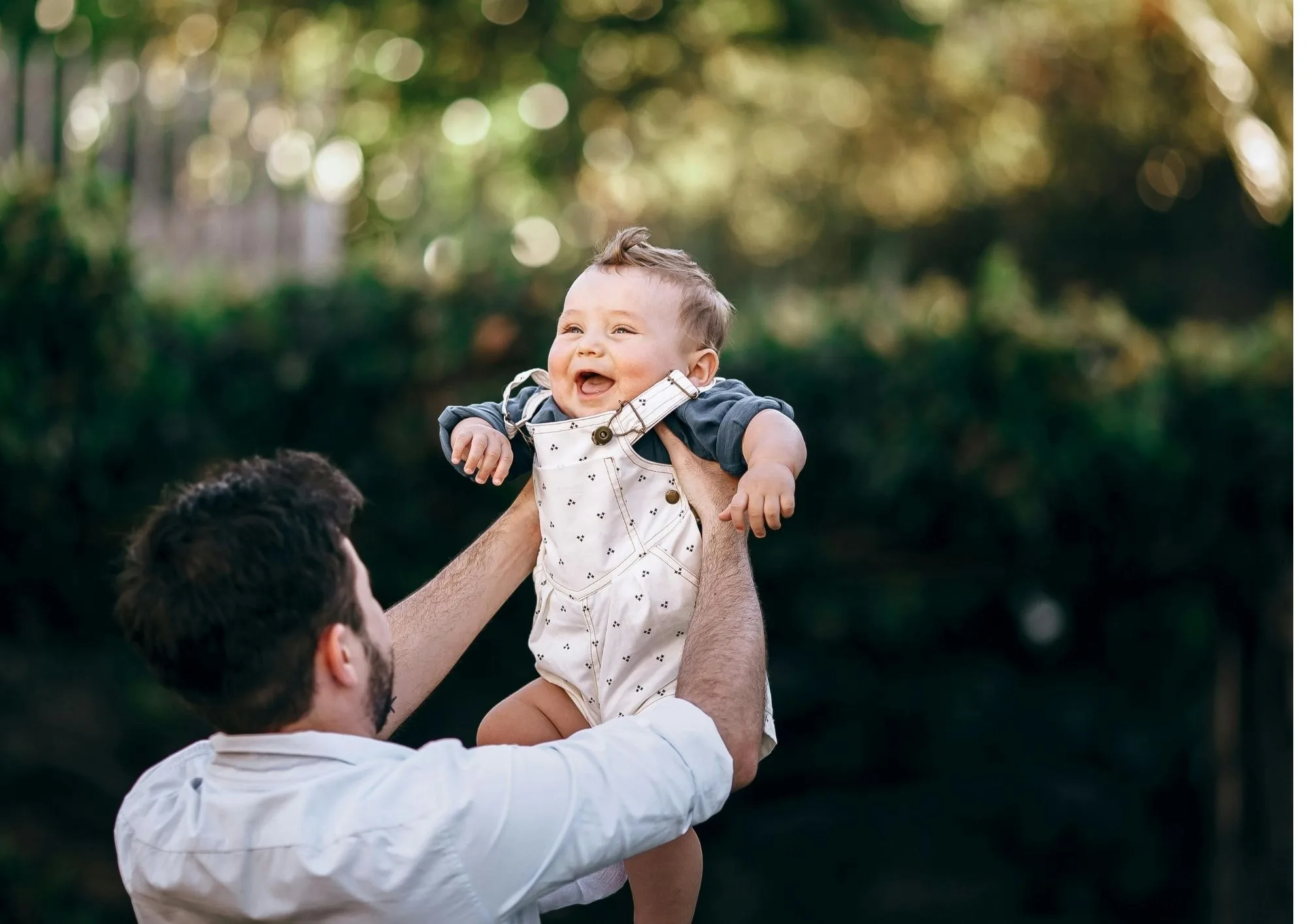Infant being lifted by adults causing laughing sound effects